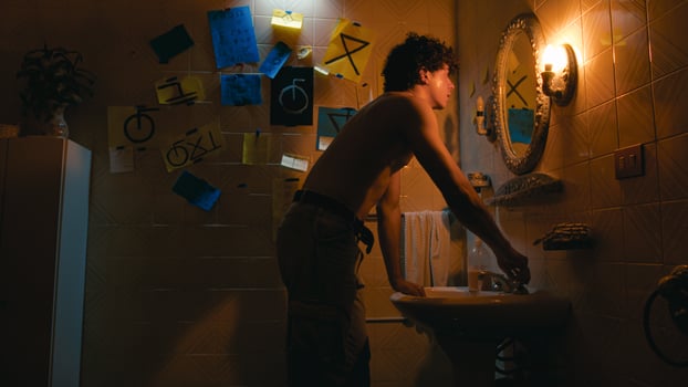 Man Washing His Face In Front Of The Bathroom Mirror photo