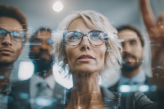 A diverse group of professionals gathers in a contemporary office. They focus on digital data displayed around them, brainstorming ideas and engaging in a strategic discussion about new advancements. photo