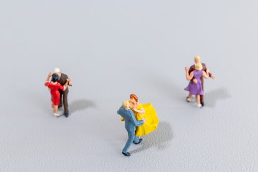 Miniature Couples Dancing on Light Background photo