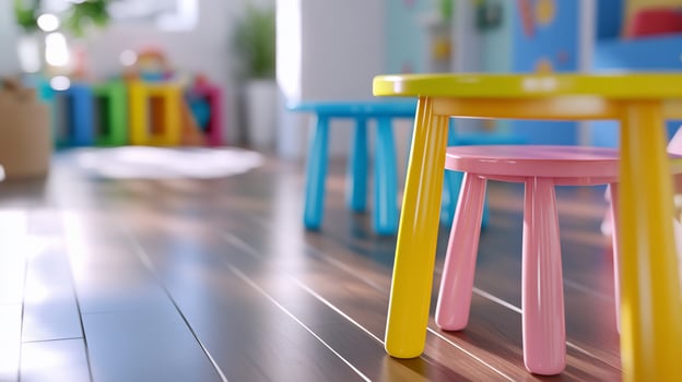 Colorful childrens tables and chairs in playroom or classroom with wood floor photo