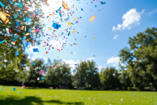 Confetti rain celebration on green lawn with blue sky background photo