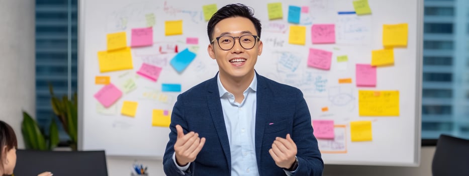 Energetic man presenting ideas at whiteboard in a collaborative office environment photo