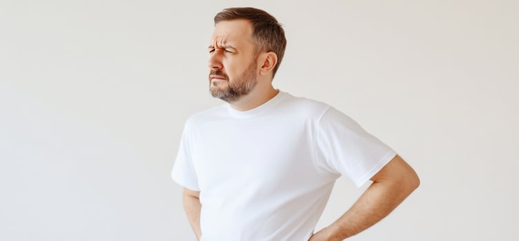 Man experiences lower back pain discomfort medical condition photo