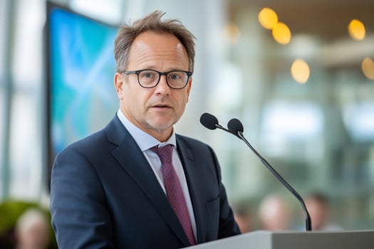 Man giving presentation speech at podium during business conference photo