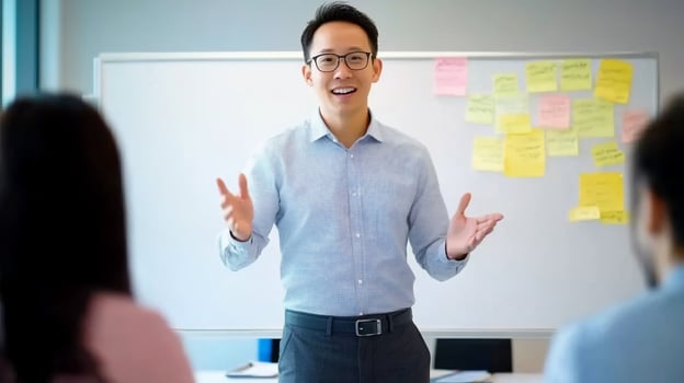 Man presenting to group with whiteboard and sticky notes in office photo