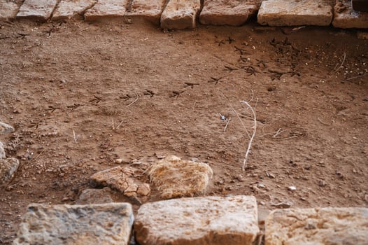 A piece of ruined old weathered brick wall and brown bricks needs to be repaired. photo