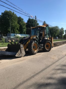 Construction equipment working on road repair in sunny weather photo