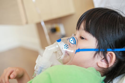 A young child with an oxygen mask on photo
