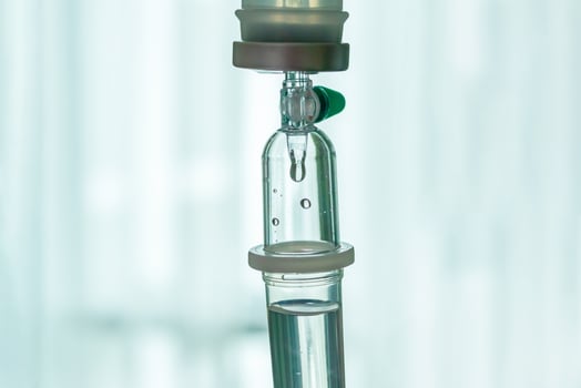 A small glass tube with a small liquid inside photo