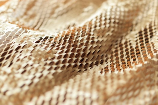 A close up of a gold fabric with a pattern photo