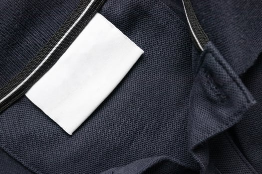 A close up of a blue jacket with a white label photo