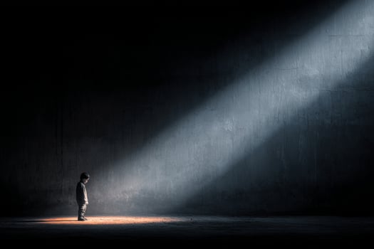 A person standing in the dark with a spotlight shining on them photo