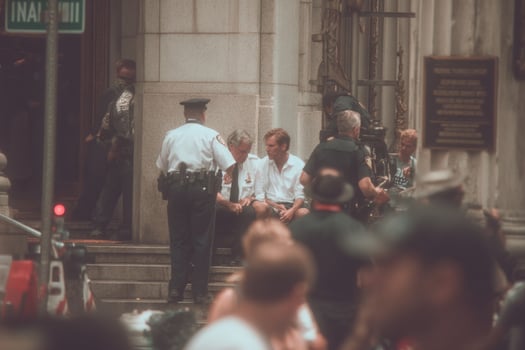A group of people sitting on the steps of a building photo