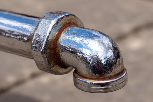 A close up of a metal pipe with a rusty end photo