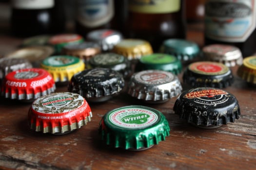 A collection of beer caps on a table photo