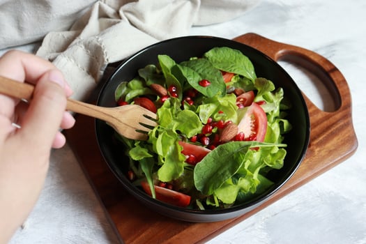 Salad plate with green lettuce, tomato, baby spinach, pomegranate and almond. photo