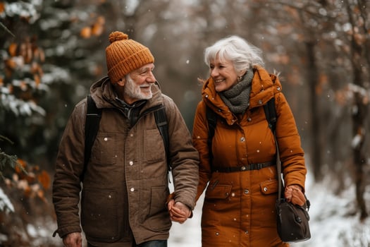 An older couple walking in the snow photo