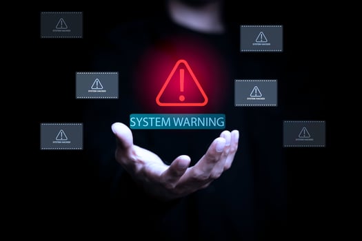 System warning alert with hacker breach notifications floating above businessman hand, representing cybersecurity threat, data breach, and network vulnerability in technology and IT security concept. photo