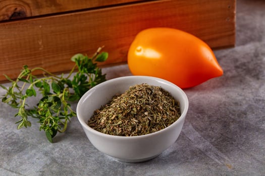 A bowl of herbs and a small orange photo