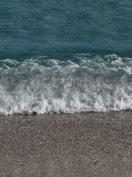 Wave breaking on sandy beach in Formentera photo