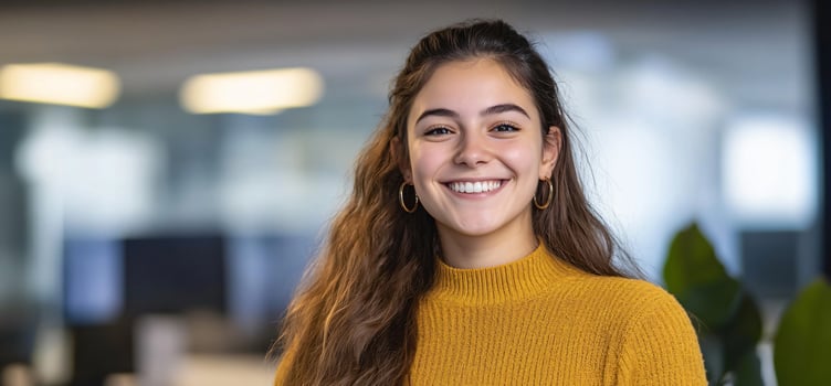 Smiling woman in yellow sweater portrait happy young female adult indoor photo