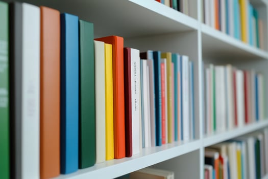 Colorful books on white shelves classic literature and knowledge resource photo
