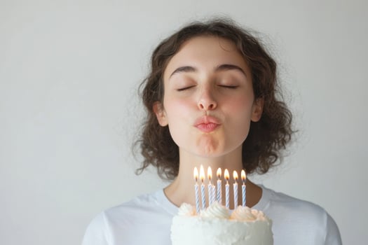 Woman blowing out birthday candles on cake celebrating special day occasion photo