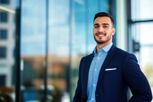Smiling business man in suit posing against modern building background portrait photo