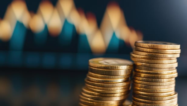 Golden coins stacked with blurry financial chart background photo