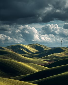 Expansive green fields with distant windmill standing under bold dramatic clouds in a peaceful countryside park with scenic open space photo