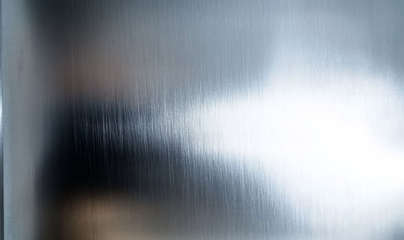 Brushed metal texture background in silver and gray colors with reflective surface photo