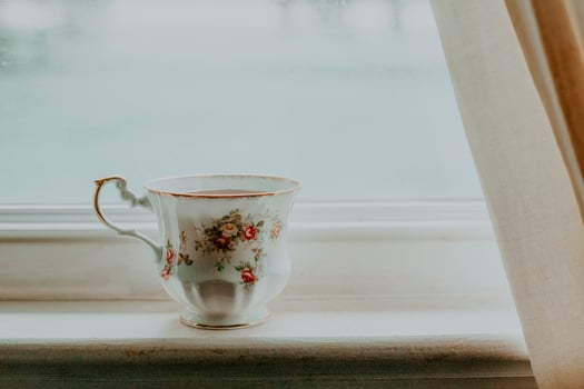 A cup of tea on a window sill photo