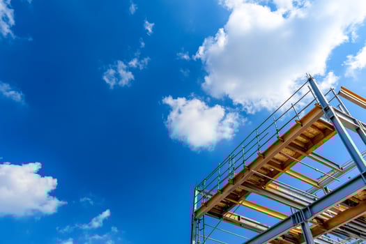 Construction framework under bright blue sky with clouds building architecture photo