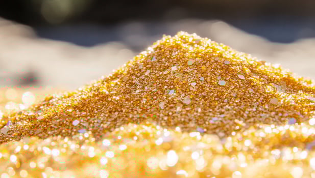 Golden glitter dust sparkling texture shimmering backdrop luxury decoration precious material design photo