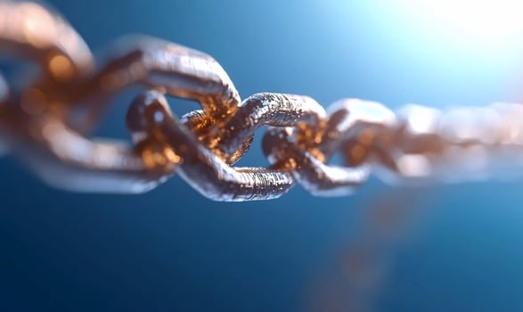 Interlocked gold chain links on blue gradient backdrop photo