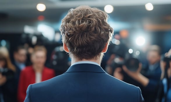 Person addressing media press conference from behind photo