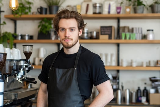 Portrait of a young barista in a cafe setting preparing coffee beverage for customer service photo