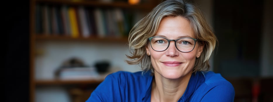 Portrait of mature woman smiling confidently with short hair indoors photo