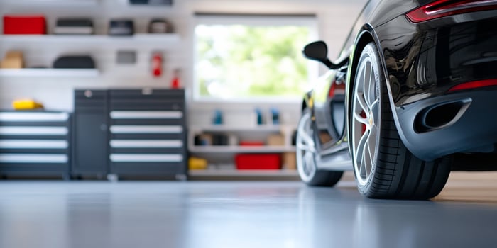 Car parked inside a modern garage with storage and clean design photo