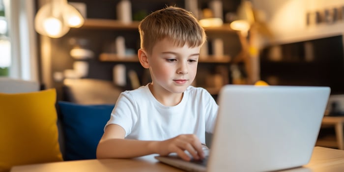 Child engaged with laptop for learning and technology use photo