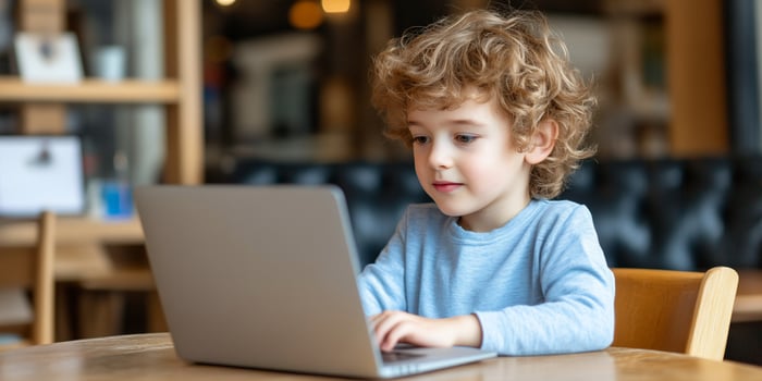 Child using laptop for education technology and digital learning photo