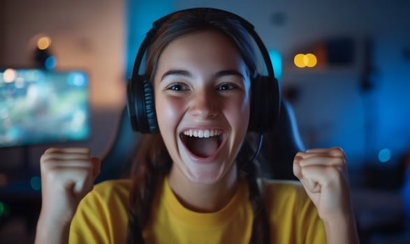 Excited young woman celebrate online game victory with enthusiasm and cheer photo