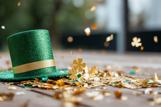Festive green hat and golden confetti still life photo