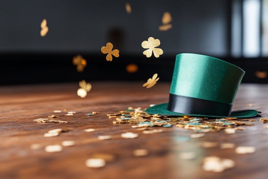 Green hat with clover confetti on wooden surface festive celebration photo