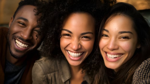 Three happy friends smiling together on a sunny day photo