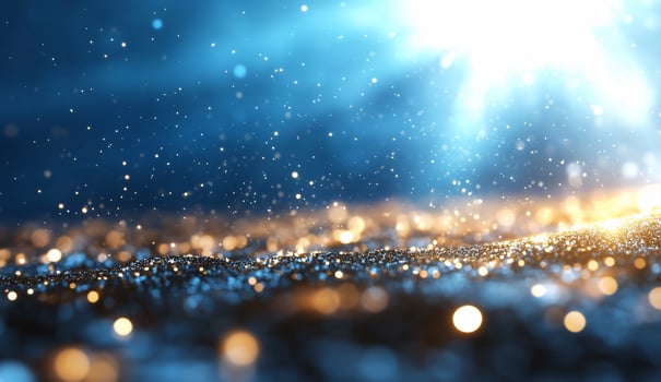 Sparkling glitter texture background with blue and gold particles photo