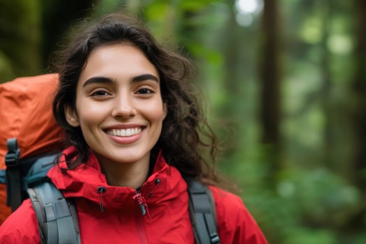 Woman hiking with backpack smiles in green forest adventure travel photo