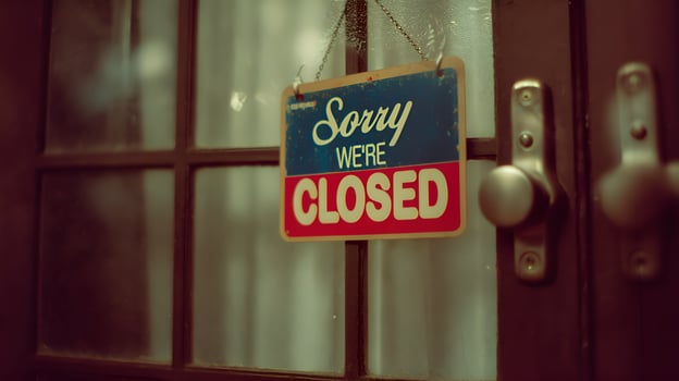Closed sign hanging on glass door of business photo