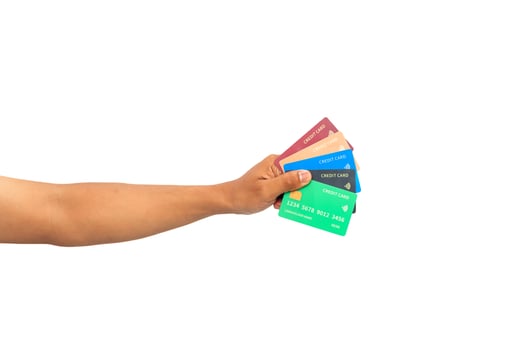 Hand holding various colorful credit cards isolated on white background for financial themes photo