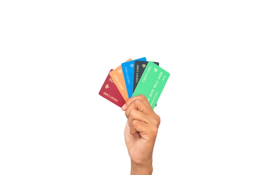 Hand holding multiple colorful credit cards against a clean white background, financial diversity photo